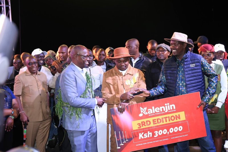 Founder of Kalenjin Music Festival Johana Ngeno hand over awards during the last edition of the festival at eldoret.