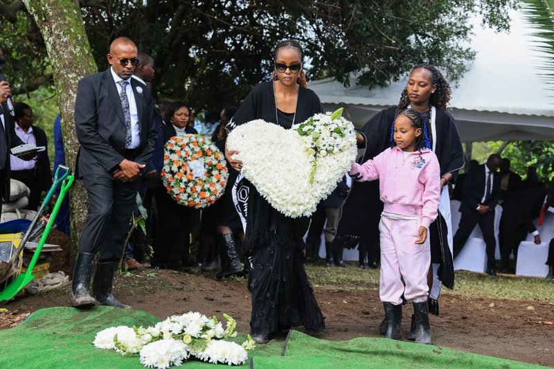 Widow of late Johana Ngeno lays a wreath of flowers on the grave of  late husband Johana Ngeno .